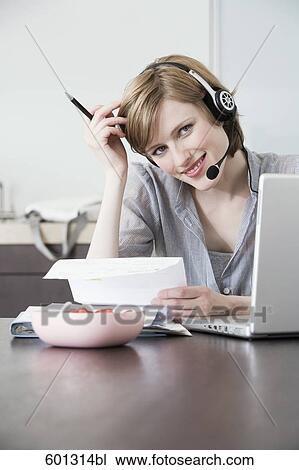 Stock Image - portrait of woman working at home with laptop computer. Fotosearch