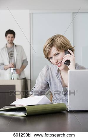 portrait of woman working from home with man making coffee View Large Photo Image Stock Image - portrait of woman working from home with man making coffee. Fotosearch