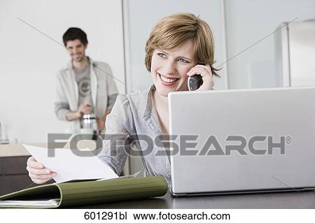 portrait of woman working from home with man making coffee View Large Photo Image Stock Image - portrait of woman working from home with man making coffee. Fotosearch