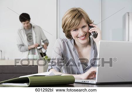 portrait of woman working from home with man making coffee View Large Photo Image Stock Image - portrait of woman working from home with man making coffee. Fotosearch