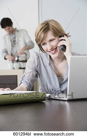 portrait of woman working from home with man making coffee View Large Photo Image Stock Image - portrait of woman working from home with man making coffee. Fotosearch