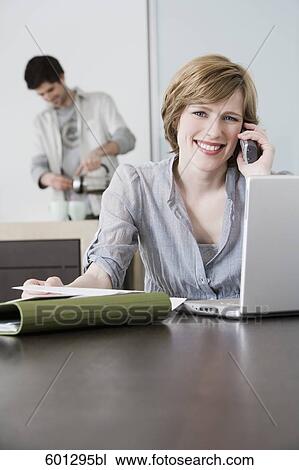 portrait of woman working from home with man making coffee View Large Photo Image Stock Image - portrait of woman working from home with man making coffee. Fotosearch