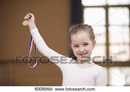 portrait of young ballet dancer holding medal View Large Photo Image Stock Image - portrait of young ballet dancer holding medal. Fotosearch