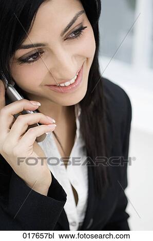 Stock Image - portrait of young businesswoman talking on mobile phone. Fotosearch