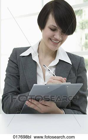portrait of young businesswoman with pen and clipboard View Large Photo Image Stock Image - portrait of young businesswoman with pen and clipboard. Fotosearch