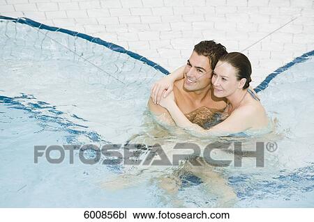 Stock Image - portrait of young couple in swimming pool. Fotosearch