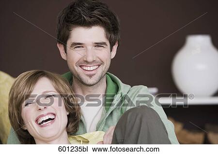portrait of young couple relaxing at home View Large Photo Image Stock Image - portrait of young couple relaxing at home. Fotosearch
