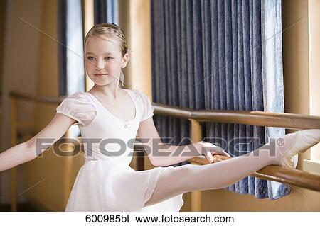 portrait of young girl exercising on ballet barre View Large Photo Image Stock Image - portrait of young girl exercising on ballet barre. Fotosearch