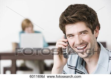 portrait of young man at home talking on the telephone View Large Photo Image Stock Image - portrait of young man at home talking on the telephone. Fotosearch
