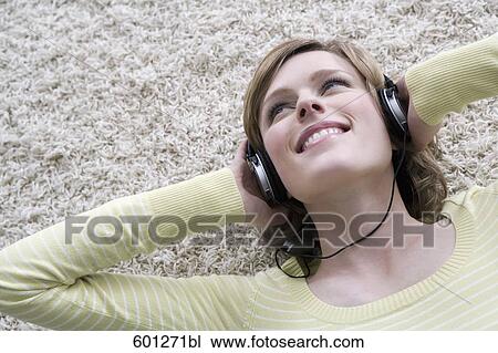 portrait of young woman at home listening to music with headphones View Large Photo Image Stock Image - portrait of young woman at home listening to music with headphones. Fotosearch