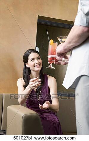 portrait of young woman getting cocktail from man View Large Photo Image Stock Image - portrait of young woman getting cocktail from man. Fotosearch