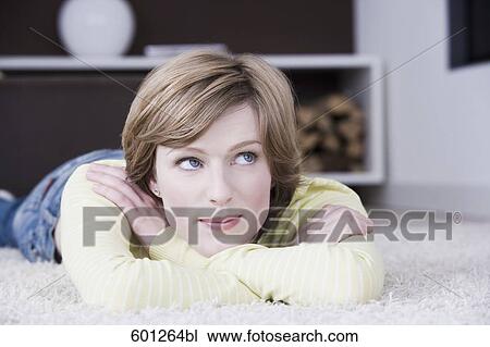 portrait of young woman lying on floor at home View Large Photo Image Stock Image - portrait of young woman lying on floor at home. Fotosearch
