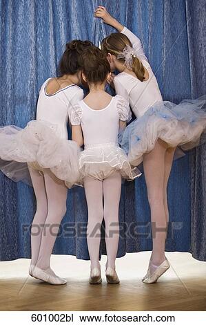 rear view of three young ballet dancers peeking through curtain View Large Photo Image Stock Image - rear view of three young ballet dancers peeking through curtain. Fotosearch