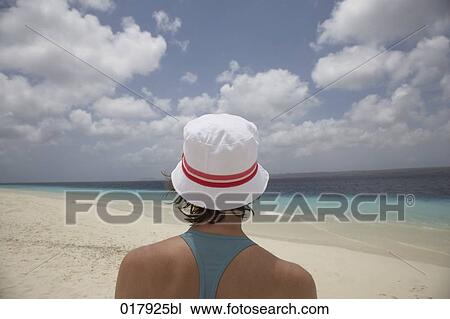 rer view of woman with white hat on sandy beach View Large Photo Image Stock Image - rer view of woman with white hat on sandy beach. Fotosearch