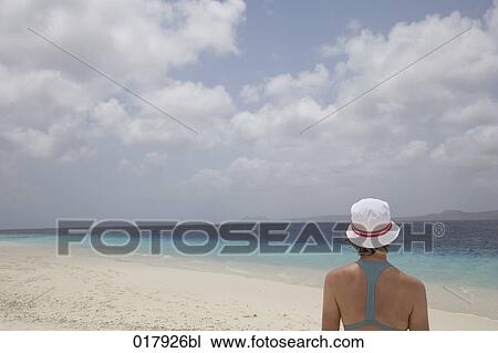 rer view of woman with white hat on sandy beach View Large Photo Image Stock Image - rer view of woman with white hat on sandy beach. Fotosearch