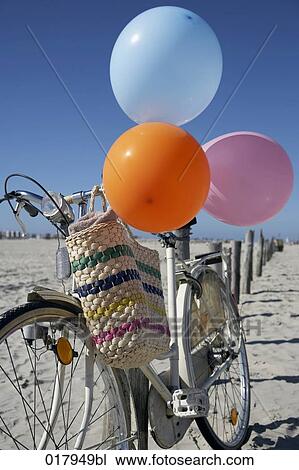 still life of bicycle with colourful balloons on beach View Large Photo Image Stock Image - still life of bicycle with colourful balloons on beach. Fotosearch