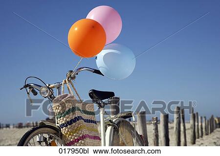 still life of bicycle with colourful balloons on beach View Large Photo Image Stock Image - still life of bicycle with colourful balloons on beach. Fotosearch