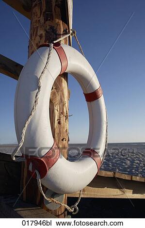 Stock Image - still life of life buoy on beach. Fotosearch