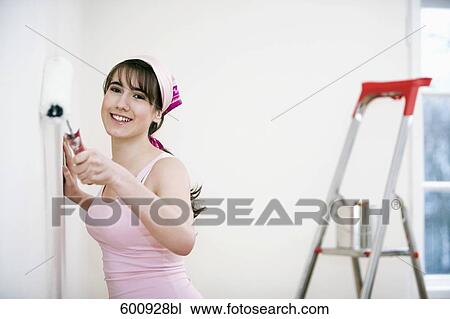 teenage girl decorating walls of her new home View Large Photo Image Stock Image - teenage girl decorating walls of her new home. Fotosearch