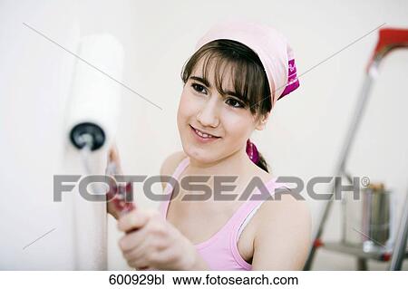 teenage girl decorating walls of her new home View Large Photo Image Stock Image - teenage girl decorating walls of her new home. Fotosearch