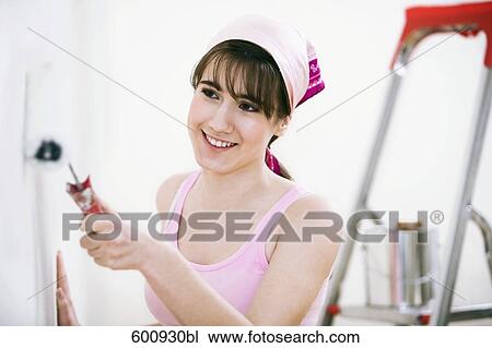 teenage girl decorating walls of her new home View Large Photo Image Stock Image - teenage girl decorating walls of her new home. Fotosearch