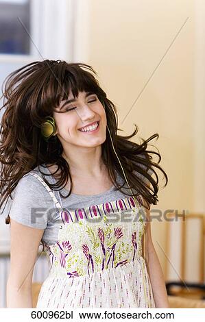 teenage girl wearing headset listening to music View Large Photo Image Stock Image - teenage girl wearing headset listening to music. Fotosearch