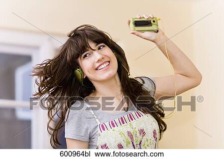 teenage girl wearing headset listening to music View Large Photo Image Stock Image - teenage girl wearing headset listening to music. Fotosearch