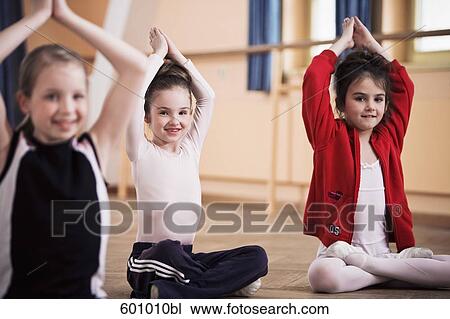 three young girls sitting cross-legged doing meditation exercises View Large Photo Image Stock Image - three young girls sitting cross-legged doing meditation exercises. Fotosearch