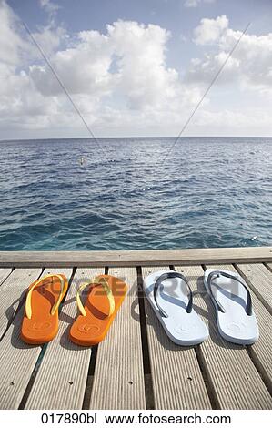 two pairs of flip flops on pier View Large Photo Image Stock Image - two pairs of flip flops on pier. Fotosearch