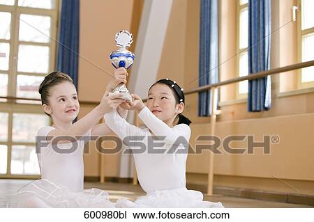 two young ballet dancers holding trophy View Large Photo Image Stock Image - two young ballet dancers holding trophy. Fotosearch