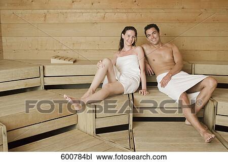 Stock Image - woman and man relaxing in sauna. Fotosearch