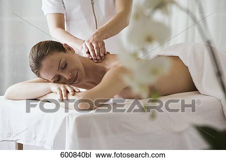 woman lying on massage bench undergoing massage treatment View Large Photo Image Stock Image - woman lying on massage bench undergoing massage treatment. Fotosearch