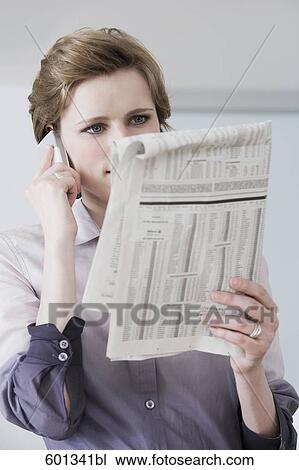 woman reading newspaper and talking on mobile phone View Large Photo Image Stock Image - woman reading newspaper and talking on mobile phone. Fotosearch