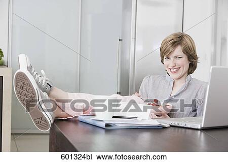 woman relaxing at home with feet on the table View Large Photo Image Stock Image - woman relaxing at home with feet on the table. Fotosearch