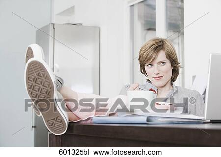 woman relaxing at home with feet on the table View Large Photo Image Stock Image - woman relaxing at home with feet on the table. Fotosearch