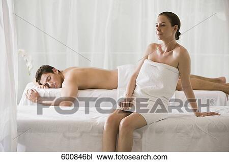 woman sitting on massage bench with man lying in background View Large Photo Image Stock Image - woman sitting on massage bench with man lying in background. Fotosearch