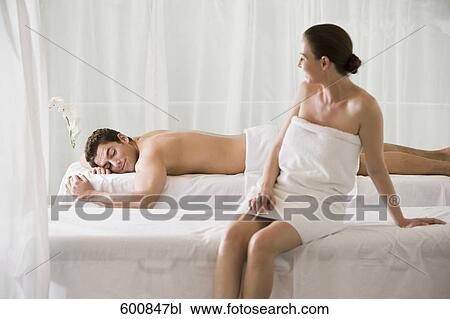 woman sitting on massage bench with man lying in background View Large Photo Image Stock Image - woman sitting on massage bench with man lying in background. Fotosearch