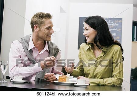 young couple at cafe eating cake together View Large Photo Image Stock Image - young couple at cafe eating cake together. Fotosearch