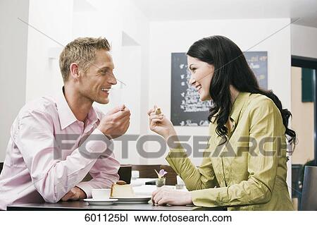 young couple at cafe eating cake together View Large Photo Image Stock Image - young couple at cafe eating cake together. Fotosearch