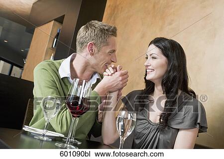 young couple at restaurant holding hands View Large Photo Image Stock Image - young couple at restaurant holding hands. Fotosearch