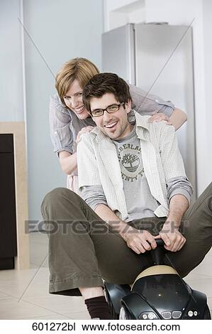 young couple having fun at home man driving toy car View Large Photo Image Stock Image - young couple having fun at home man driving toy car. Fotosearch