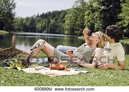 young couple having picnic man feeding woman View Large Photo Image Stock Image - young couple having picnic man feeding woman. Fotosearch