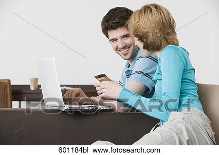young couple in front of laptop computer with credit card View Large Photo Image Stock Image - young couple in front of laptop computer with credit card. Fotosearch