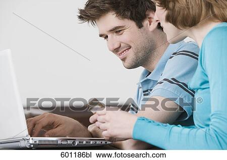 young couple in front of laptop computer with credit card View Large Photo Image Stock Image - young couple in front of laptop computer with credit card. Fotosearch