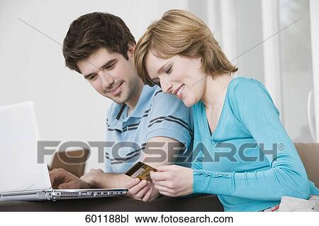 young couple in front of laptop computer with credit card View Large Photo Image Stock Image - young couple in front of laptop computer with credit card. Fotosearch