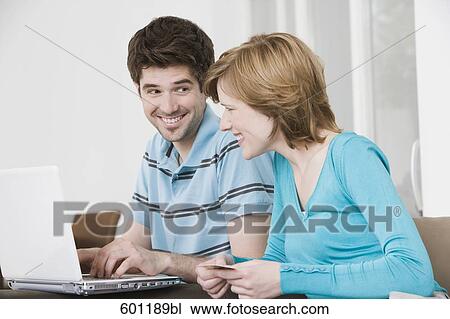 young couple in front of laptop computer with credit card View Large Photo Image Stock Image - young couple in front of laptop computer with credit card. Fotosearch