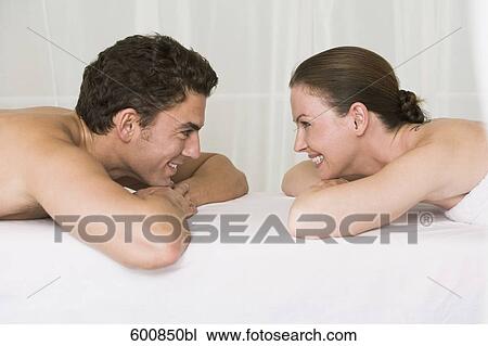 young couple lying on massage bench smiling at each other View Large Photo Image Stock Image - young couple lying on massage bench smiling at each other. Fotosearch