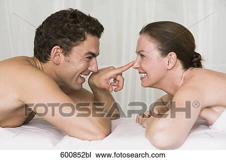young couple lying on massage bench flirting with each other View Large Photo Image Stock Image - young couple lying on massage bench flirting with each other. Fotosearch