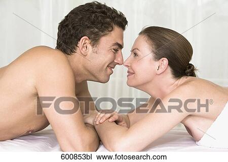 young couple lying on massage bench tenderly looking at each other View Large Photo Image Stock Image - young couple lying on massage bench tenderly looking at each other. Fotosearch