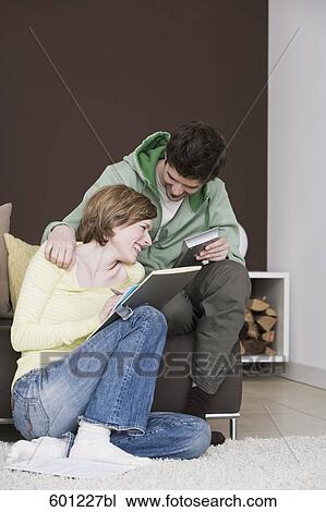 young couple reading documents at home together View Large Photo Image Stock Image - young couple reading documents at home together. Fotosearch